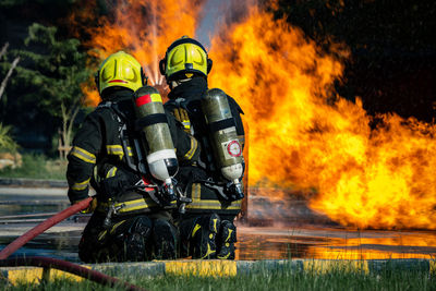 Firefighters are conducting fire drills by spraying water to extinguish the raging fire.