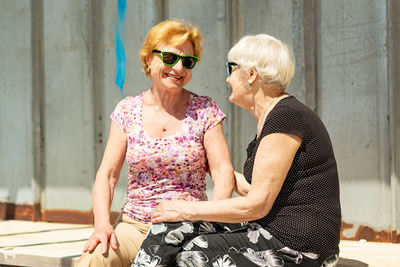 Two elderly women are happy to meet each other