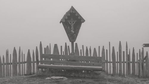 Wooden posts on beach against clear sky