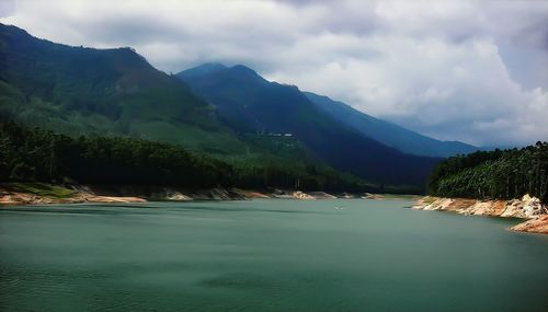 Scenic view of mountains against cloudy sky