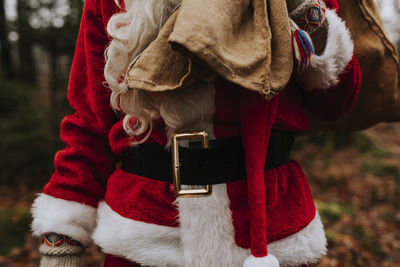 Mid section of person wearing santa costume