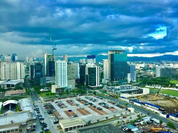 High angle view of city street against cloudy sky