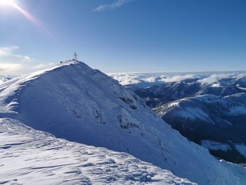 Scenic view of snow covered mountains against sky