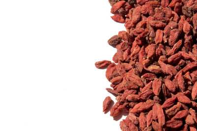 Close-up of dried goji berries against white background