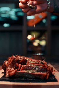 Cropped hand of person preparing food