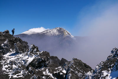 Scenic view of snowcapped mountains against clear blue sky