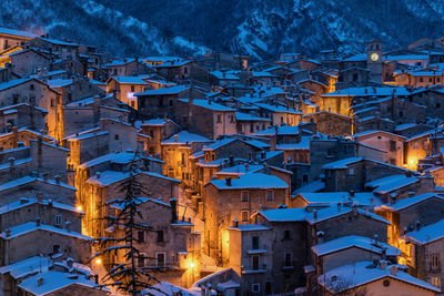 Low angle view of illuminated buildings in city at night