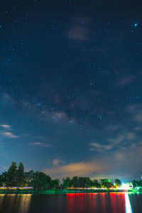 Scenic view of lake against sky at night