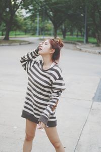 Woman standing on footpath