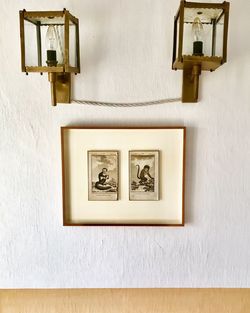 Close-up of lamp mounted on wall at home