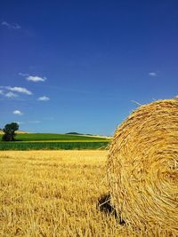 Scenic view of field against cloudy sky