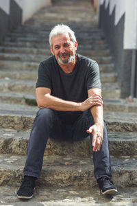 Portrait of smiling man sitting on steps