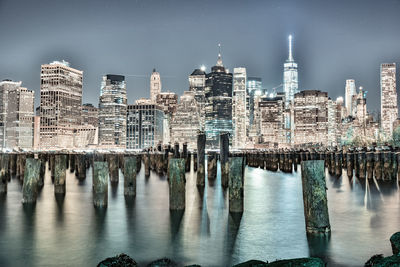 Reflection of buildings in lake at night