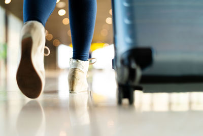 Traveler with suitcase walking with carrying luggage and passeng