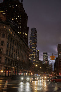 Illuminated city street and buildings at night