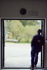 Farmer standing at entrance of barn