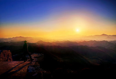 Scenic view of silhouette mountains against sky during sunset