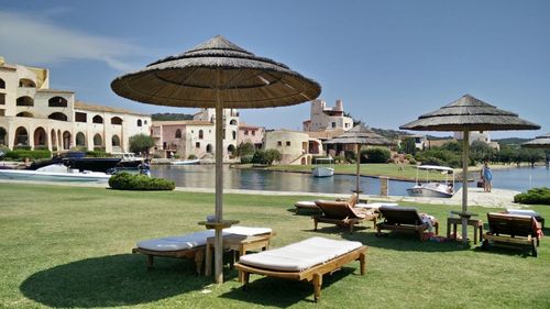 Chairs and tables against clear blue sky