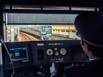 Rear view of man driving train