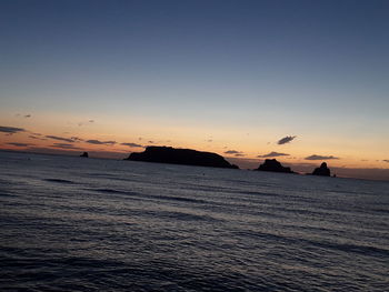 Scenic view of sea against clear sky during sunset