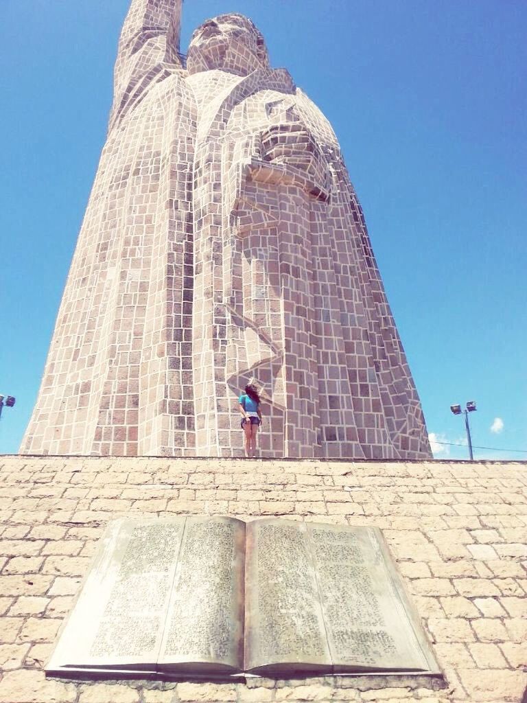 architecture, built structure, building exterior, low angle view, blue, clear sky, lifestyles, famous place, leisure activity, tower, casual clothing, tourism, men, travel destinations, travel, religion, place of worship, standing