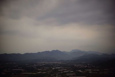 Cityscape against cloudy sky