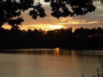 Scenic view of lake against orange sky