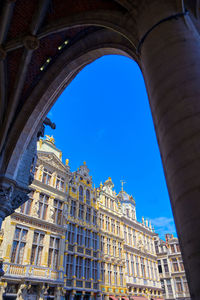 Low angle view of buildings against blue sky