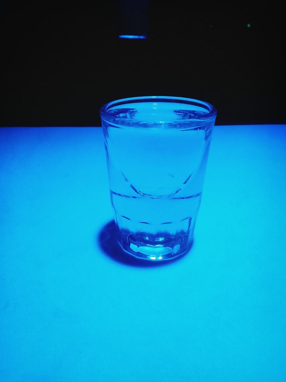 drink, refreshment, food and drink, drinking glass, glass - material, freshness, indoors, transparent, table, close-up, still life, glass, alcohol, blue, water, cold temperature, ice cube, cocktail, no people, studio shot