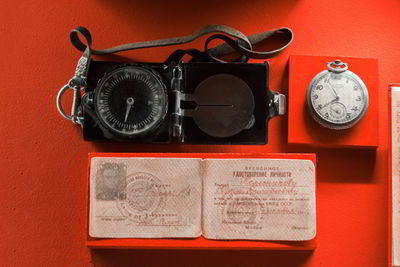 High angle view navigational compass and passport on table