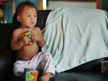 Cute baby girl sitting at home