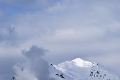 Low angle view of snowcapped mountain against sky