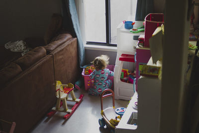 High angle view of girl playing with toys at home