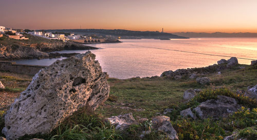 Scenic view of river against sky at sunset