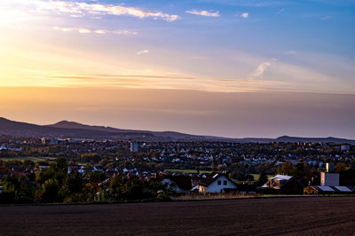 Townscape against sky at sunset