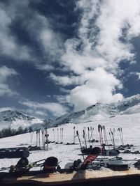 Ski lift over snowcapped mountains against sky