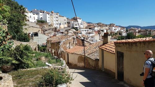 Buildings in town against clear sky