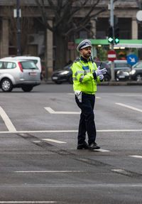 Full length of man standing on street in city