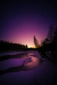 Scenic view of frozen lake against sky at night