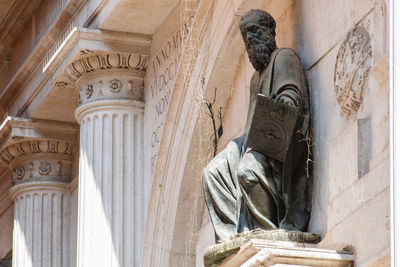 Low angle view of statue against building