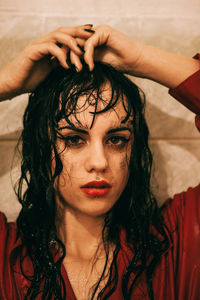 Close-up portrait of wet young woman in bathroom