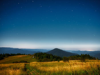 Scenic view of field against sky at night