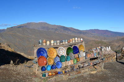 Graffiti on mountain range against clear blue sky