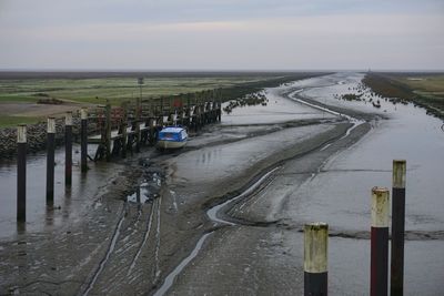 Panoramic view of road amidst field against sky