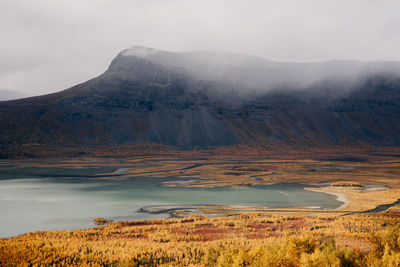 Scenic view of lake and mountains against sky