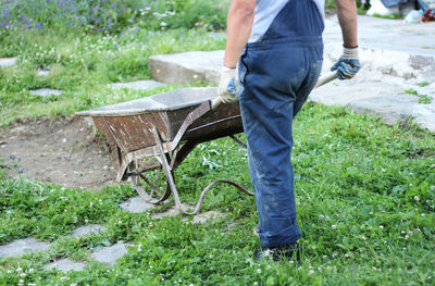 Low section of man working on grass