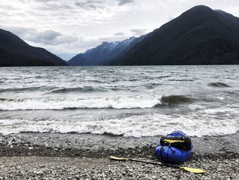 Scenic view of sea and mountains against sky