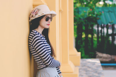 Young woman wearing hat standing outdoors