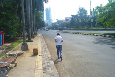 Rear view of man walking in city