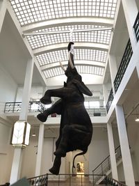 Low angle view of statue hanging against ceiling